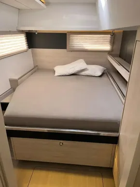 Cozy bedroom in 2019 Leopard 45 yacht with modern design and neutral tones.