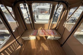 Interior view of a 1994 Linssen 360 AC boat with wooden flooring and colorful rug.