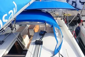 2019 Jeanneau Sun Odyssey 440 sailboat with blue canopy docked at marina.