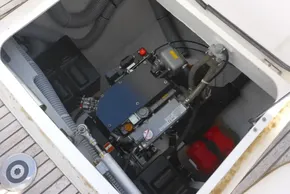 Engine compartment of a 2017 Lagoon 42 catamaran, showcasing mechanical components and hoses.