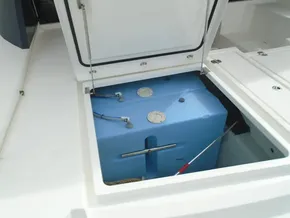 Open storage compartment on a 2017 Leopard 45 boat showing a blue water tank.