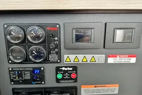 Control panel of a 2025 Robertson and Caine Leopard 46 Powercat with gauges and warning labels.