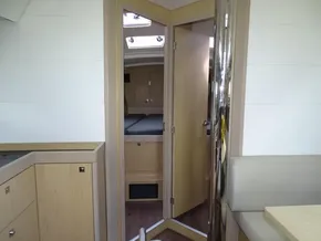 Interior of 2017 Beneteau Oceanis 45 yacht, featuring modern wood cabinetry and cozy cabin space.