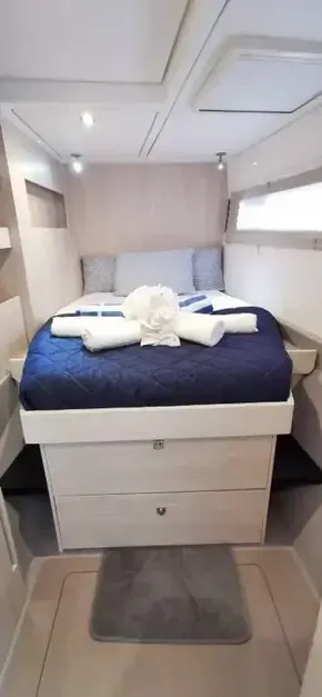 2019 Leopard 51 Powercat bedroom with bed, drawers, and towels.