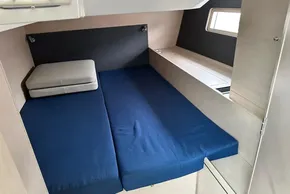Interior cabin of 2023 Beneteau Oceanis 51.1 yacht with blue bedding.