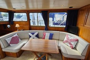 Luxurious interior of 2005 Stevens 1200 Vlet yacht with cozy seating and nautical decor.