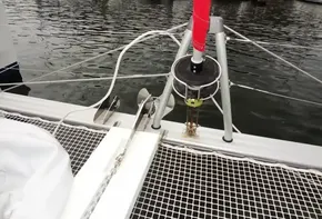Bow of Lagoon 42 catamaran (2020) with anchor and netting at marina.
