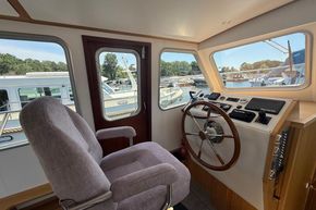 Interior of 2024 Piper 12c boat with steering wheel and control panel.