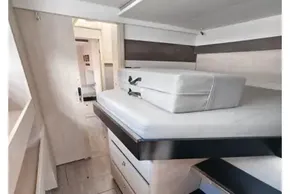 Modern interior of 2019 Leopard 50 yacht with sleek wooden cabinetry and compact sleeping area.