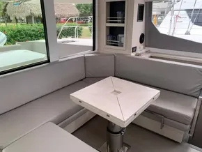 Modern interior of 2021 Leopard 45 yacht with gray seating and compact table.