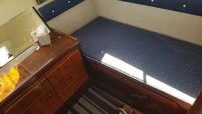 1982 Fairline Mirage 29 Aft Cabin interior with bed and wooden cabinetry.