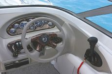 Crownline Bowrider 200 LS Helm Optional wood trimmed dash and matching steering wheel insert. The standard depth sounder comes with outside air and water temperature readouts.