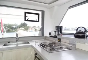 Modern kitchen in 2017 Leopard 45 yacht with stove, sink, and appliances.