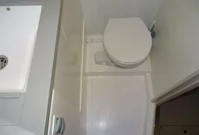 Compact bathroom in 2017 Leopard 45 yacht with toilet and sink.