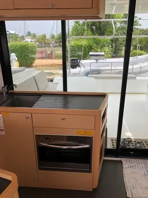 Modern kitchen area in a 2020 Lagoon 42 catamaran with outdoor view.