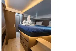 Luxurious cabin interior of 2021 Leopard 50 yacht with modern design and cozy bedding.
