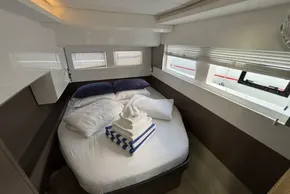 2024 Leopard 40 Powercat cabin with cozy bed and stacked towels.