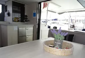 Leopard 45 yacht interior, 2017 model, featuring a modern kitchen and dining area with lavender decor.