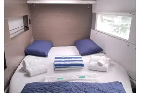 Cozy cabin interior of 2022 Leopard 45 yacht with neatly arranged bedding.
