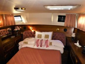 Cozy bedroom interior of 1995 Aquafibre Bounty Boats 10/70 with elegant decor and soft lighting.