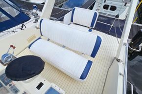 Flybridge seating on 1989 Princess 35 yacht, featuring white and blue cushioned seats.
