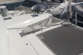 2024 Lagoon 42 catamaran deck with netting and docked boats in background.