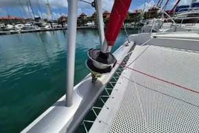 Leopard 45 catamaran deck with marina view, showcasing rigging and netting.