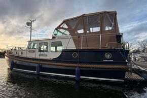 Linssen 360 AC 1994 yacht with brown canopy, docked on calm water.