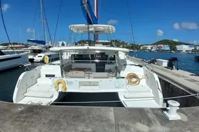 2020 Lagoon 46 catamaran docked at a marina under clear blue skies.