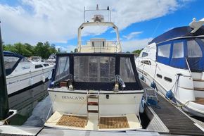 1989 Princess 35 Flybridge yacht docked at marina, surrounded by other boats.