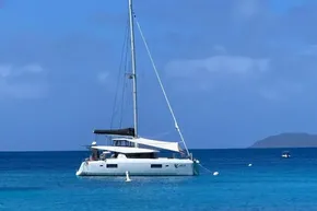 2024 Lagoon 42 catamaran anchored in clear blue ocean waters.