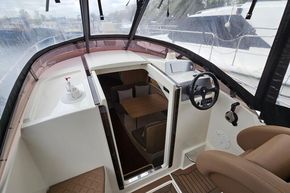 2023 Balt 818 Titanium boat interior with steering wheel and cabin view.