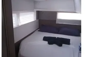 Luxurious cabin interior of 2022 Leopard 45 yacht with skylight and neatly arranged bed.