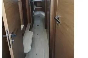 Interior hallway of 2020 Lagoon 46 catamaran with wooden doors and flooring.