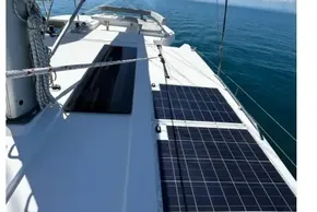 Sailing catamaran Leopard 42 (2022) with solar panels on deck, cruising in calm ocean waters.