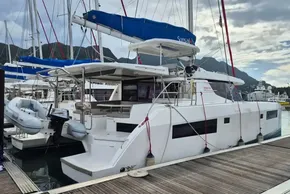 2020 Leopard 45 catamaran docked at marina with inflatable dinghy attached.