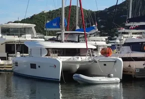 2020 Lagoon 42 catamaran docked at a marina with a small dinghy.