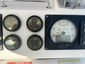 Boat dashboard with fuel, amp gauges, and tachometer on 2019 Leopard 45.