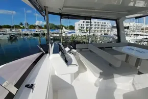 2024 Leopard 40 Powercat interior with seating area, docked at marina under clear blue sky.