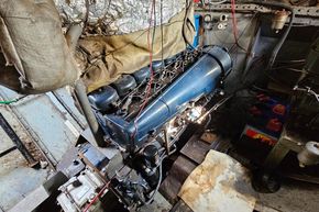 Engine room of a 1927 Classic Dutch Barge with visible wiring and machinery.