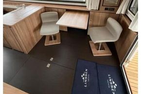 Interior of 2025 Linssen 45 SL Sedan yacht with modern seating and large windows.