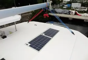 Leopard 45 catamaran (2017) with solar panels on deck, docked near a marina.