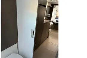 Modern interior of 2022 Leopard 42 yacht, featuring a compact bathroom and sleek cabinetry.