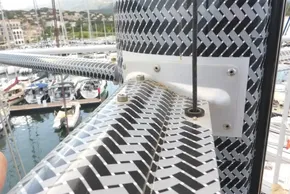 Close-up of a 2017 Lagoon 42 catamaran mast with a patterned design in a marina.