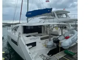 2020 Leopard 40 catamaran docked, featuring a blue sail and inflatable dinghy.