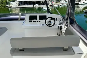 Helm of 2022 Leopard 53 Powercat with modern controls and waterfront view.