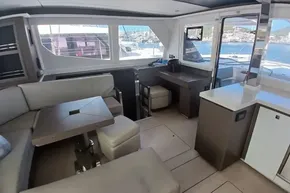 Interior of 2022 Leopard 45 yacht with modern seating and panoramic windows.