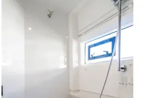 Modern shower area in 2025 Leopard 46 yacht with sleek design and window.